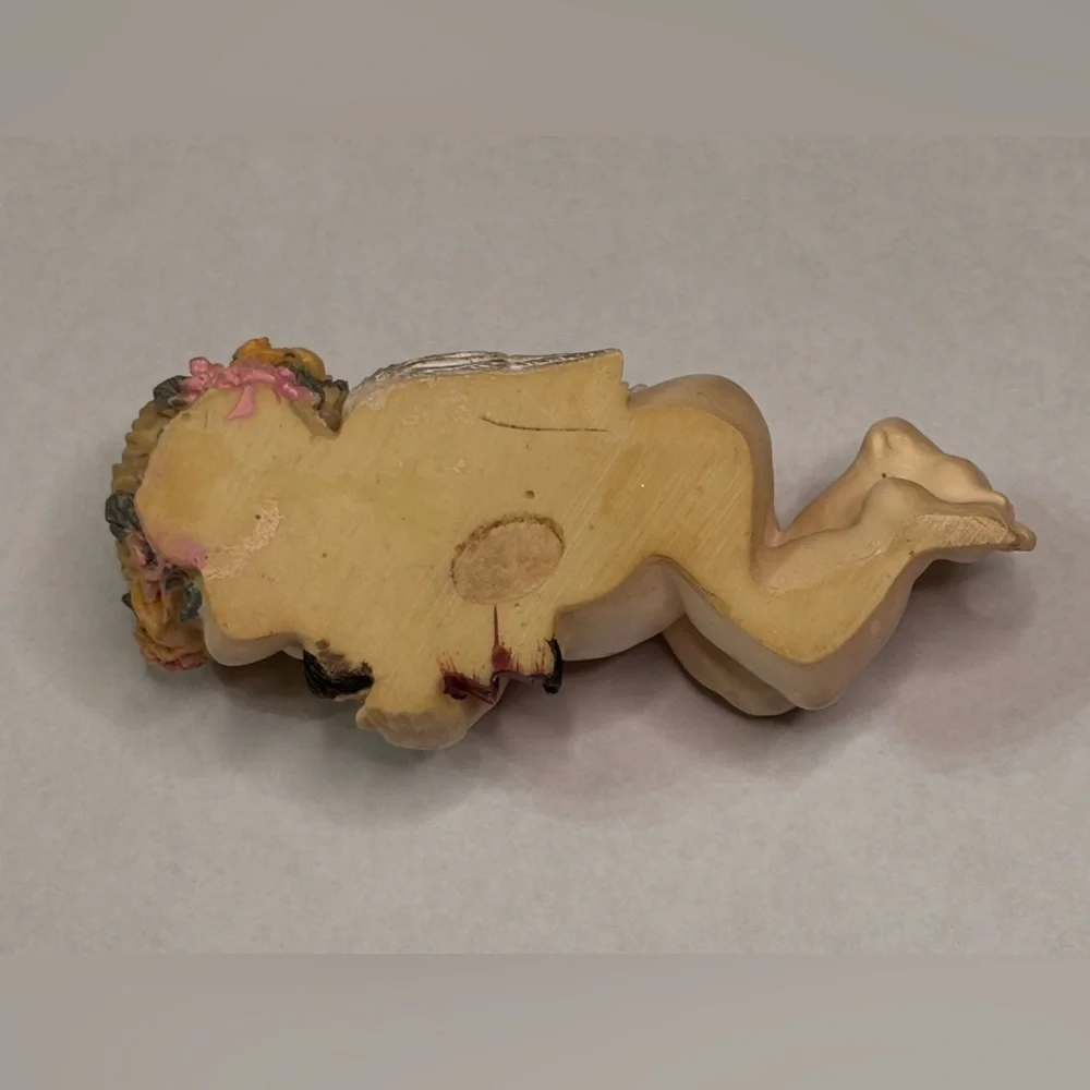 Sleeping Cherub Figurine holding a doll with Floral Crown